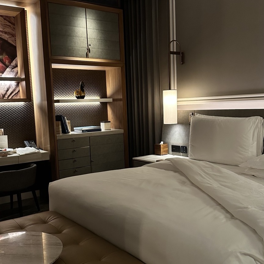 An elegant hotel bedroom prepared for the evening