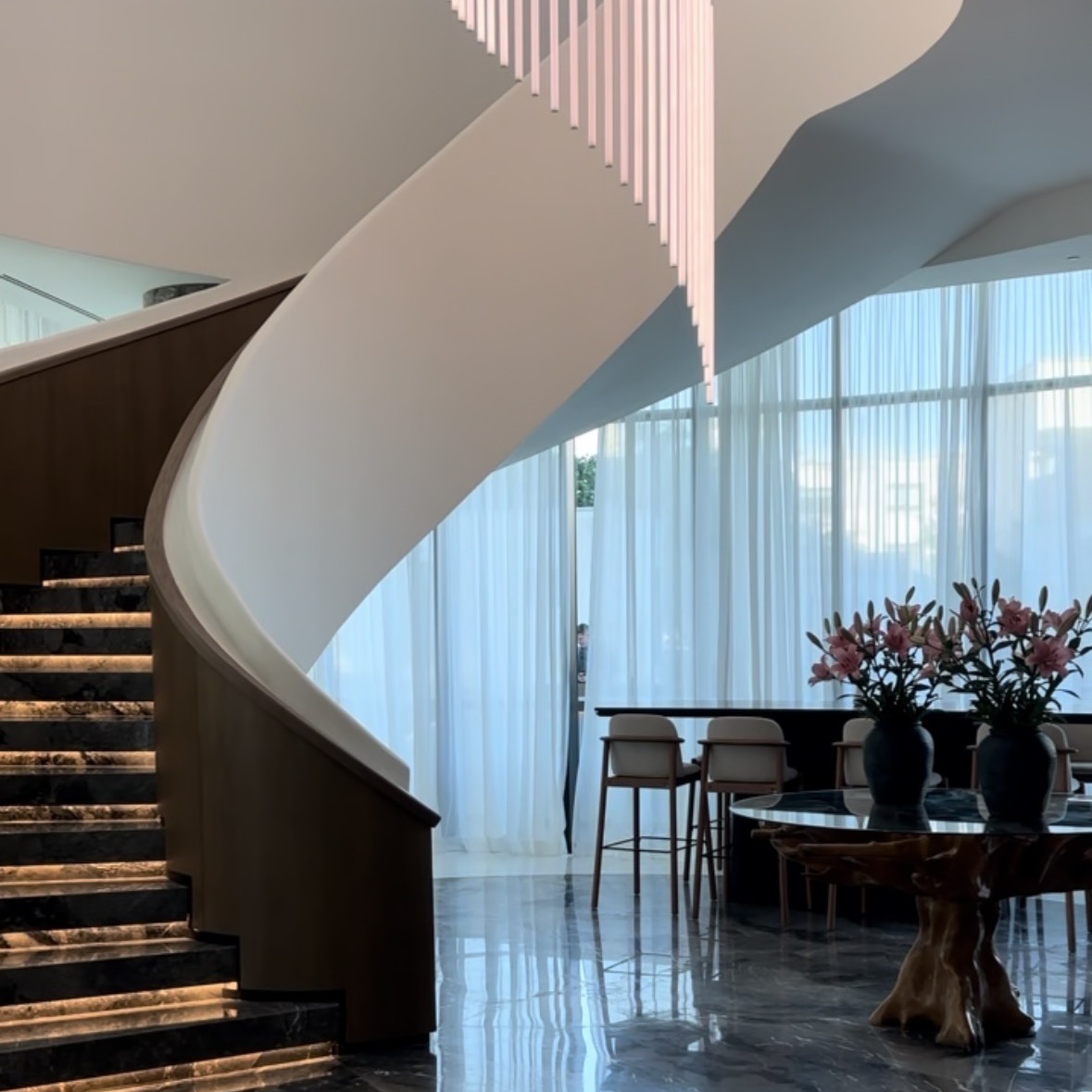 A sculptural staircase and refined hotel lounge
