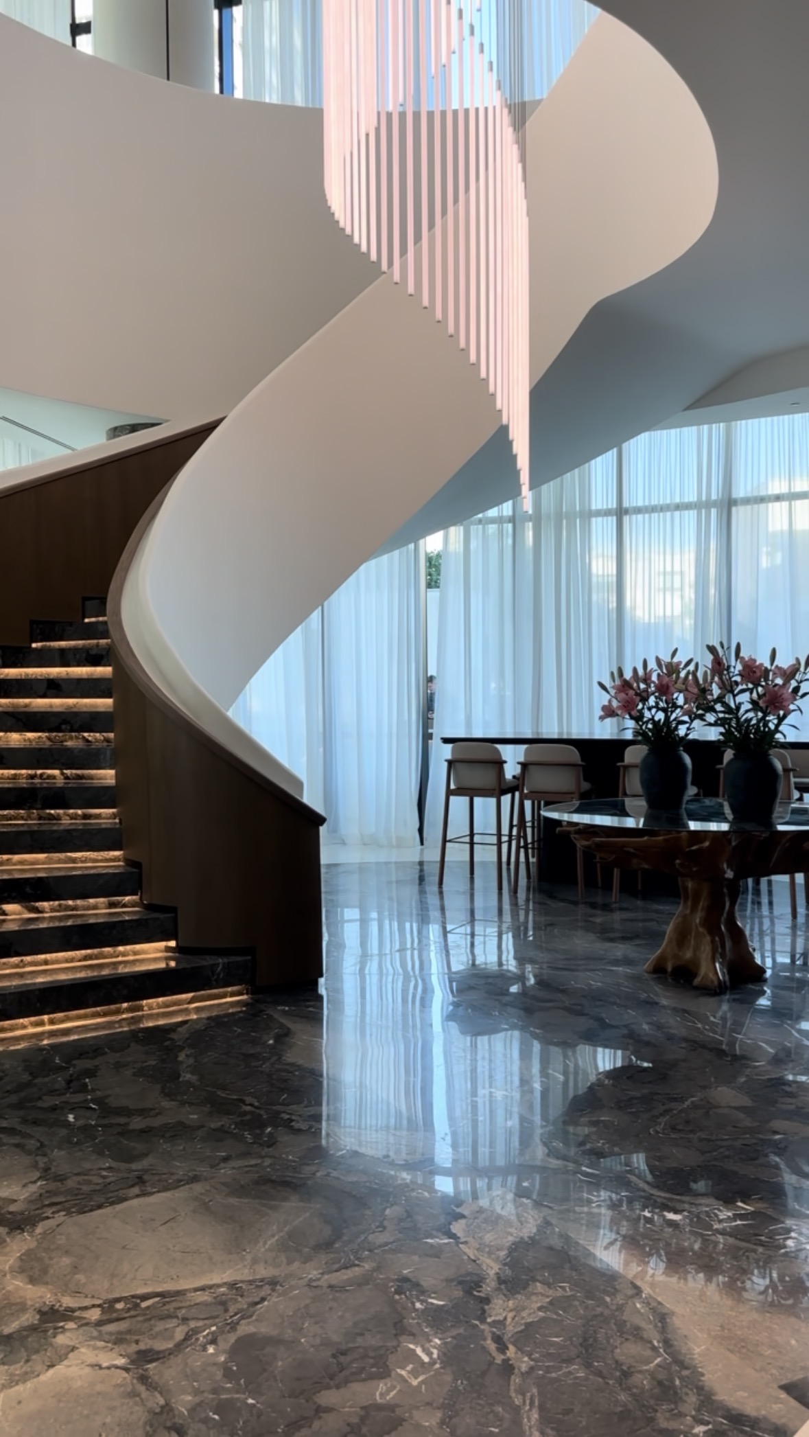 A sculptural winding staircase in an elegant luxury hotel